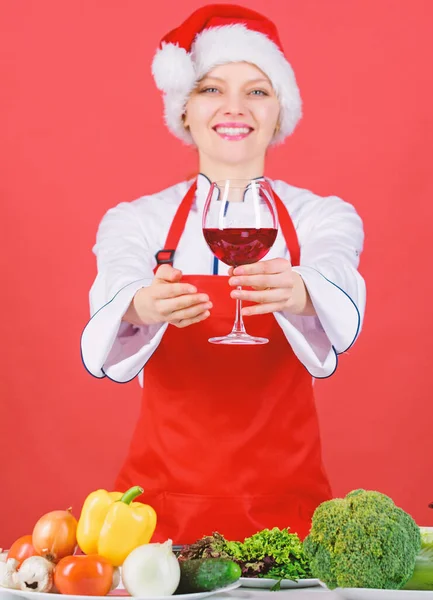 No stress. Best christmas recipes. Enjoy easy ideas for holiday parties and holiday dinners. Festive menu concept. Christmas dinner ideas. Christmas menu. Woman chef cooking wear santa hat drink wine