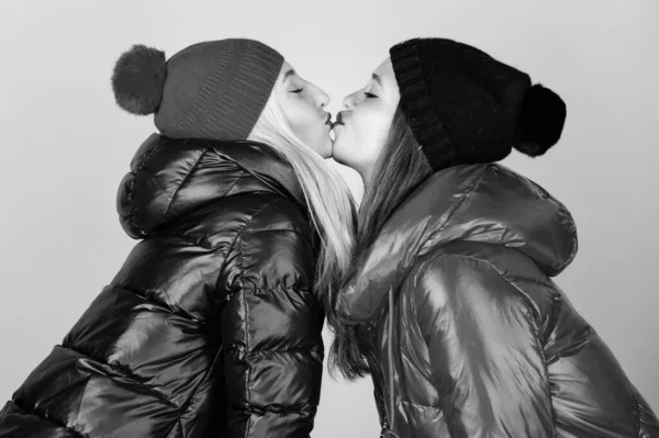 Glad to see you. Best friends forever. Winter kiss. Best friends matching outfits. Soulmates girls kiss. Women wear down jackets. Girls makeup face wear winter jackets. Fashion trend. Winter season — Stock Photo, Image