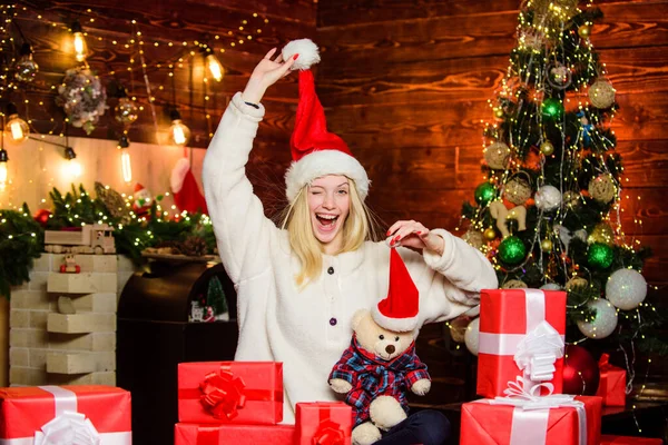Μικρό μυστικό. Η ευτυχισμένη γυναίκα λατρεύει τα δώρα. Χειμερινές πωλήσεις. Χαρούμενο κορίτσι κόκκινο καπέλο Σάντα. γιορτάζουν το νέο έτος στο σπίτι. Χριστουγεννιάτικο δώρο. Ημέρα πυγμαχίας. Τελευταία προετοιμασία. Χριστούγεννα — Φωτογραφία Αρχείου