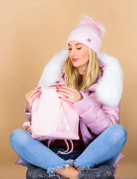 Good time. happy winter holidays. warm winter clothing. shopping. girl in puffed coat. faux fur fashion. flu and cold season. Leather bag fashion. woman in beanie hat with backpack
