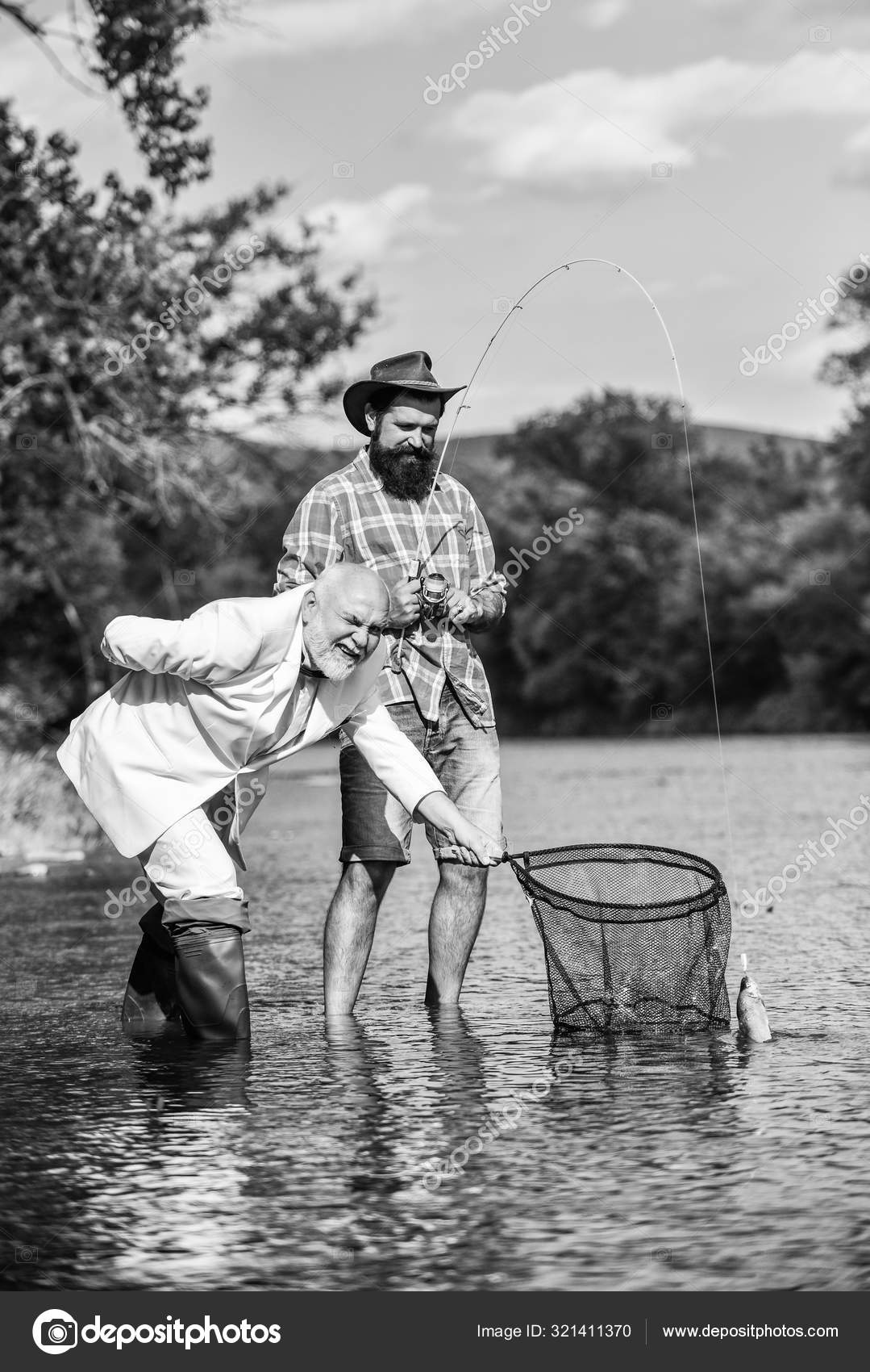 Family is Best. retired dad and mature bearded son. Catching and fishing  concept. happy fishermen. Good profit. Two male friends fishing together. fly  fish hobby of businessman. retirement fishery Stock Photo by ©