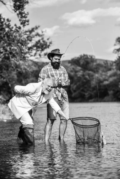 Family is Best. retired dad and mature bearded son. Catching and fishing concept. happy fishermen. Good profit. Two male friends fishing together. fly fish hobby of businessman. retirement fishery — Stock Photo, Image