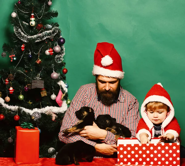 Xmas holiday concept. Man and boy in Santa hat — Stock Photo, Image