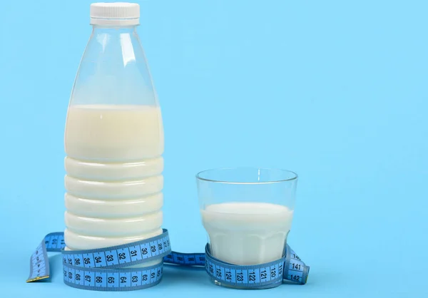 Flasche und Glas Milch mit blauem Maßband — Stockfoto