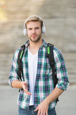 Düzgün bak. Ses kitabı konsepti. Eğitim teknolojisi. Öğrenciyim. Okul hayatı. Müziği dinle. Modern ve dijital gençlik. Şık bir adam. Üniversite öğrencisi kulaklıkları akıllı telefon. Çevrimiçi eğitim