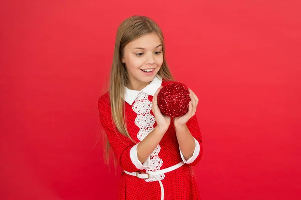 School party. Child hold shimmering decor ball. Festive decor concept. Beautiful decor. Christmas party. Winter holidays. Playful mood. Christmas celebration idea. Happy face. Shine and glitter