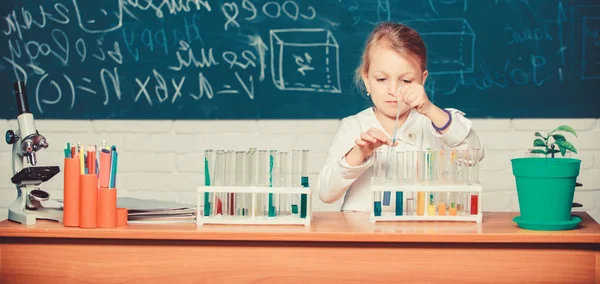 Chica linda pupila jugar con tubos de ensayo y líquidos de colores. Experimento químico escolar. Educación escolar. Interesante enfoque para aprender. Al chico le gusta experimentar. Explora e investiga. Lección escolar — Foto de Stock