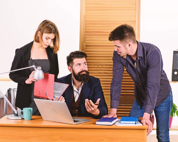 Ad hoc meeting. Managers leading informal business meeting. People making great business discussion in meeting room. Business persons typing meeting report on laptop