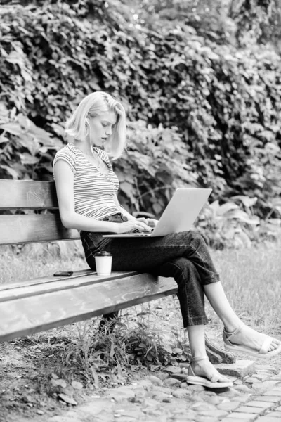 girl runs her blog on notebook. woman drink coffee. Inspiration for blogging. modern woman with notebook blogging outdoor. summer online. girl blogger write post for social network. Sharing thoughts