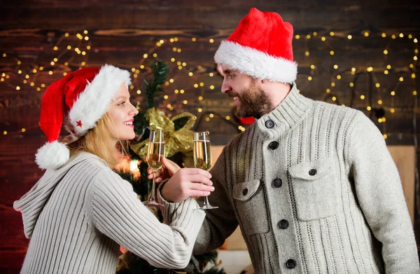 Consolidate friendship with special feast rite. Man and woman simultaneously drink glasses. Celebrating christmas together. Couple in love enjoy christmas holiday celebration. Christmas tradition