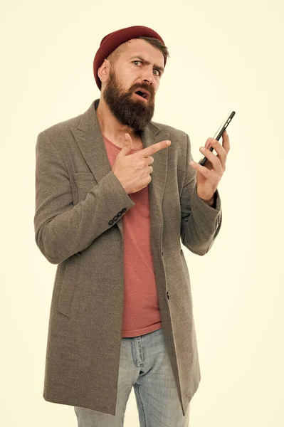 Hipster smartphone call friend. Mobile call concept. Important conversation. Man bearded hipster hold mobile phone white background. Stylish guy use mobile phone. Difficulties mobile communication