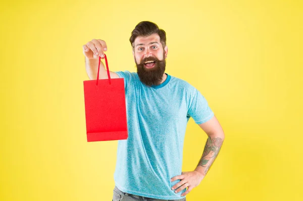 Take advantages from sale. Buy product. bearded man go shopping. Shopping concept. mature male cheerful with fashion purchase. small present. Happy hipster hold paper bag. Man with purchase — Stock Photo, Image