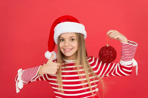 Christmas party. Winter holidays. Playful mood. Christmas celebration ideas. Shine and glitter. Child Santa Claus costume hat. Happy smiling face. Beautiful detail. Positivity concept. Cheerful mood — Stock Photo, Image