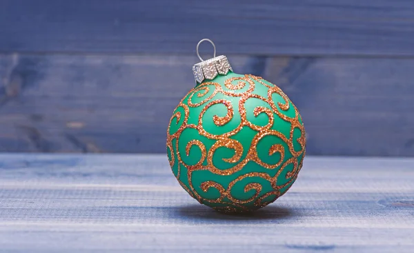 Decorate christmas tree with traditional toys. Symbol of new year and christmas holidays. Celebrate christmas. Christmas ball decoration on blue vintage wooden background. Winter holiday concept — Stock Photo, Image