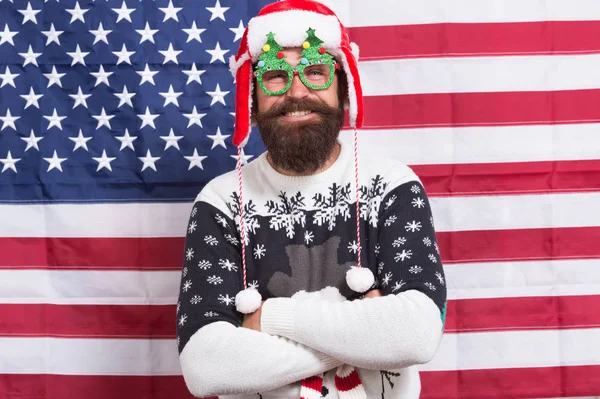 Decor and accessory. Man wear knitted sweater. American tradition. Santa Claus on american flag. Xmas and new year. Tradition of patriotism. Christmas tradition from USA. My country and tradition