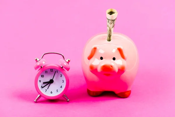 Banking account. Bankruptcy and debt. Pay for debt. Bank collector service. Economics and finance. It is time to pay. Piggy bank stuffed dollar cash and alarm clock. Financial crisis. Credit debt