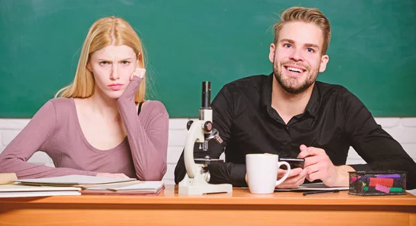 Biology lesson. Students studying university. Genetics and engineering. Difficult university subject. Scientific experiment. Guy and girl at desk with microscope. Studying in college or university
