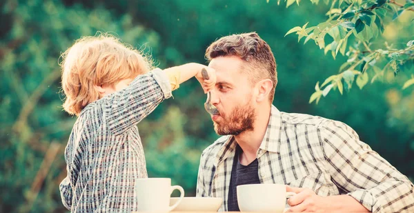 small boy child with dad. they love eating together. Weekend breakfast. father and son eat outdoor. organic and natural food. healthy food. Family day bonding. Happy family concept