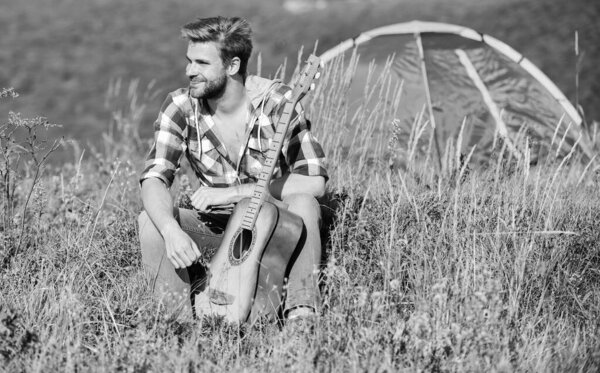 Musician looking for inspiration. Summer vacation highlands nature. Dreamy wanderer. Pleasant time alone. Peaceful mood. Guy with guitar contemplate nature. Wanderlust concept. Inspiring nature