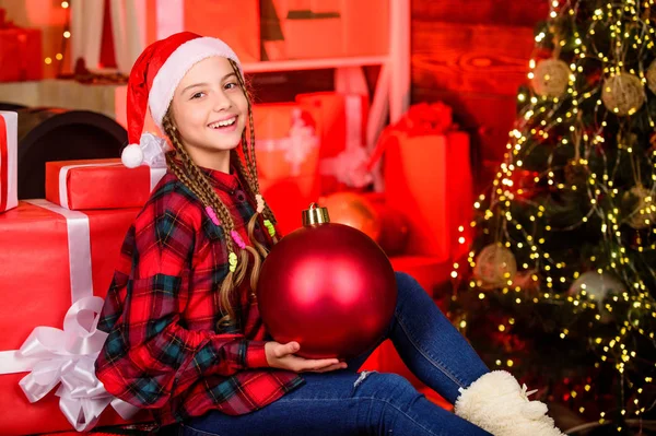 Spread love. Winter holiday. Christmas concept. Child fancy santa enjoy celebration new year. Small cute girl with big ball christmas tree. Christmas spirit. Decor shop. Favorite color. Red style