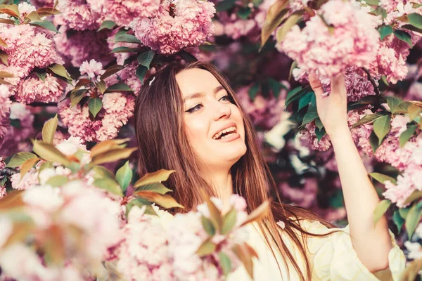 Girl in cherry blossom flower. Sakura tree blooming. Cosmetics concept. Gorgeous flower and female beauty. Woman in spring flower bloom. Soft and tender. Natural cosmetics for skin. Floral paradise