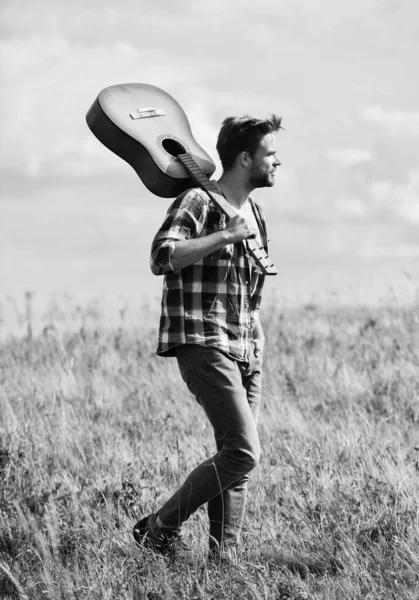 Music makes you smarter. sexy man with guitar in checkered shirt. western camping and hiking. cowboy man with acoustic guitar player. country music song. hipster fashion. happy and free