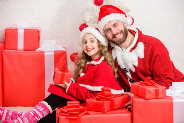 Dad in santa costume give gift to daughter cute kid. Happy childhood. Christmas family holiday. Make your childs holiday extra special this year. Father christmas concept. Christmas gift for child