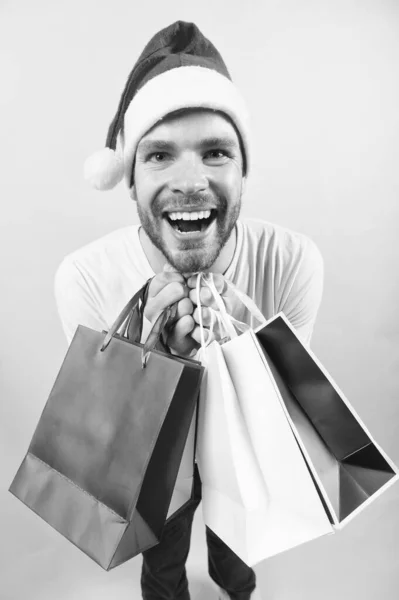 Man santa hold shopping bags on orange background — Stock Photo, Image