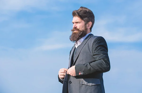Beard fashion trend. Start with grooming routine and ultimately lead better world. Man bearded hipster wear formal suit blue sky background. Vintage style beard. Facial hair beard and mustache care