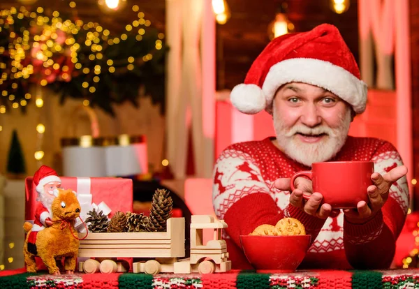 bearded man eat cookies. winter holiday mood. santa have dinner. for santa. grandpa drink milk. christmas composition. ready for new year party. xmas party celebration. present time