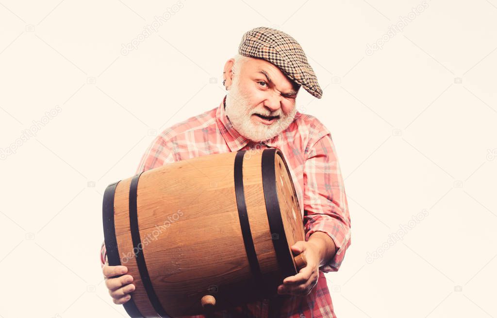 Retro man with a beer barrel. Barman. wooden barrel. oktoberfest festival. brewery for maturing alcohol. Homemade wine. Man bearded senior carry wooden barrel for wine. Fermentation product