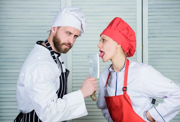 Cooking is sexy. Sharp knife professional tool. Man use sharp cleaver knife. Couple playful with dangerous knife. Metal blade. Dangerous lick. Chef hold cleaver knife tool while woman lick blade — Stock Photo, Image