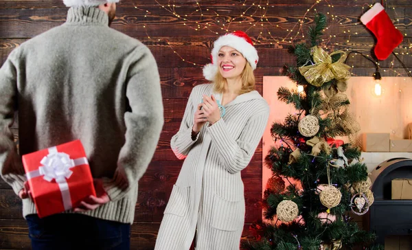 Man carry gift box behind back. Woman smiling face santa. Christmas surprise concept. Giving and sharing. Generosity and kindness. Surprising his wife. Prepare surprise for darling. Winter surprise