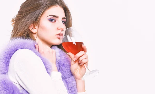 Woman enjoy wine. Girl fashion makeup wear fur coat hold wine glass. Lady curly hairstyle like expensive wine. Luxury life concept. Reasons drink red wine in wintertime. Alcohol and cold weather — Stock Photo, Image