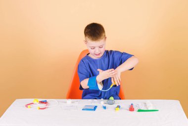 Tıp kavramı. Tıbbi muayene. Tıp eğitimi. Oyun oyna. Çocuk sevimli çocuk gelecek doktor kariyer. Sağlıklı bir hayat. Sağlık. Çocuk küçük doktor stetoskop ve tıbbi aletler ile masa oturtun
