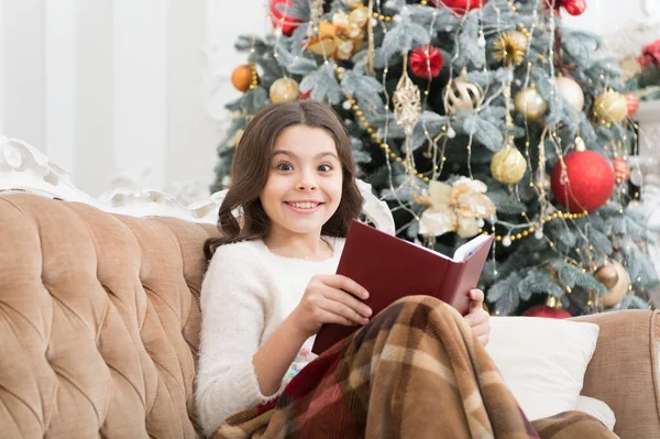 Magical atmosphere. Fantasy genre. Bookstore concept. Childhood literature. Winter wonderland. Adorable girl reading book christmas eve. Cozy concept. Child enjoy winter holidays. Winter vacation