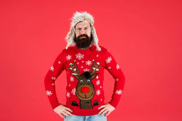 Join holiday party craze and host Ugly Christmas Sweater Party. Winter party outfit. Buy festive clothing. Sweater with deer. Hipster bearded man wear winter sweater and hat. Happy new year — Stock Photo, Image