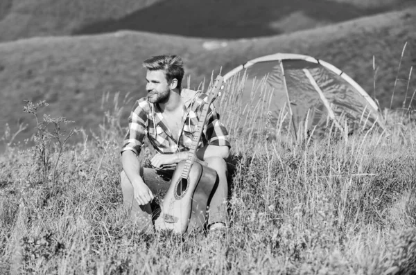 Marzycielski wędrnik. Przyjemny czas sam. Spokojny nastrój. Facet z gitarą kontemplować naturę. Koncepcja Wanderlust. Inspirująca natura. Muzyk szuka inspiracji. Letnie wakacje Highlands Nature — Zdjęcie stockowe