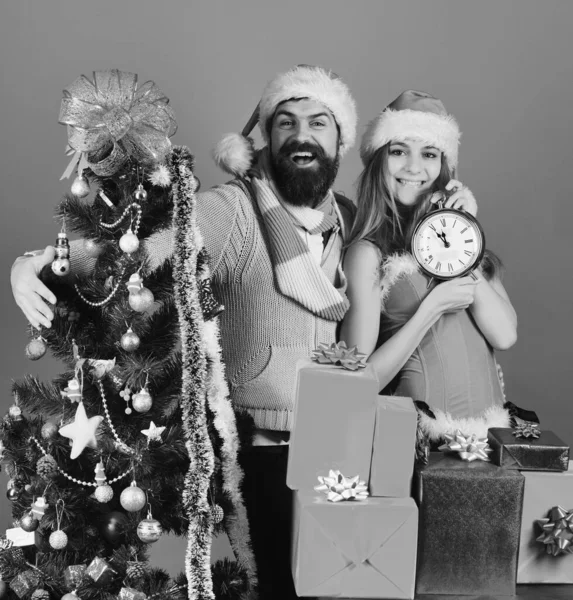 Babbo Natale e ragazza sexy con orologio e scatole regalo — Foto Stock