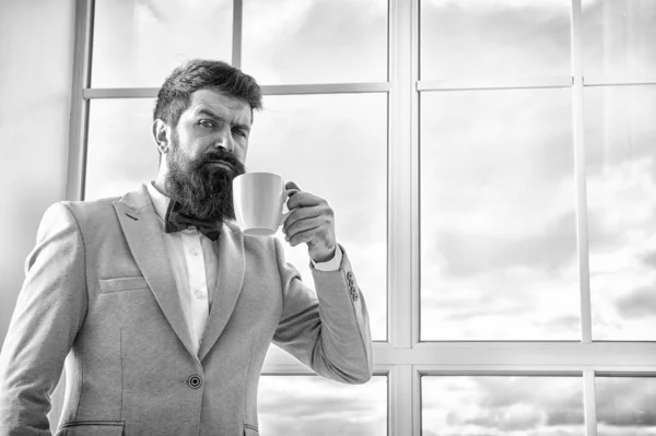 But first coffee. Man groom drinking coffee early in morning. Beginning of great day. Important day in his life. Get ready. Enjoy every minute. Hipster in tuxedo with bow tie making sip of coffee