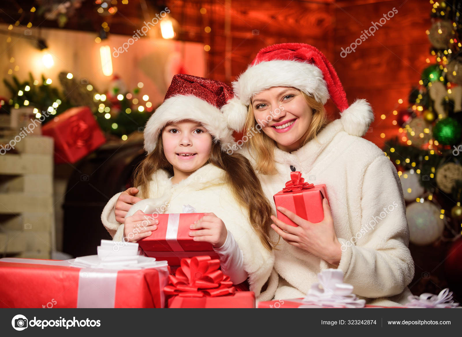 Merry Christmas Mother And Daughter Love Holidays Xmas Gift Boxes Open Present Small Child Girl With Mom In Santa Hat Winter Shopping Sales Happy Family Celebrate New Year Stock Photo Image