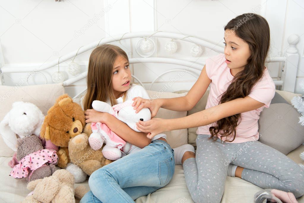 Give it to me. Kids play toys bed. Little girls spend time together. Teach sister sharing toys. Greedy sisters. Friendship sisterhood relations. Toys shop. Cute soft toys. Generosity and greediness