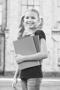 Library of her dreams. Cute library reader. Small child go to library. Adorable little girl borrow books from school library. Bibliopole. Bookstore