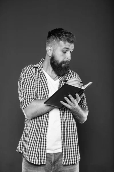 Writing means sharing thoughts and ideas. Hipster writing in notebook on grey background. Bearded man doing writing task. Creative writing professor — Stock Photo, Image