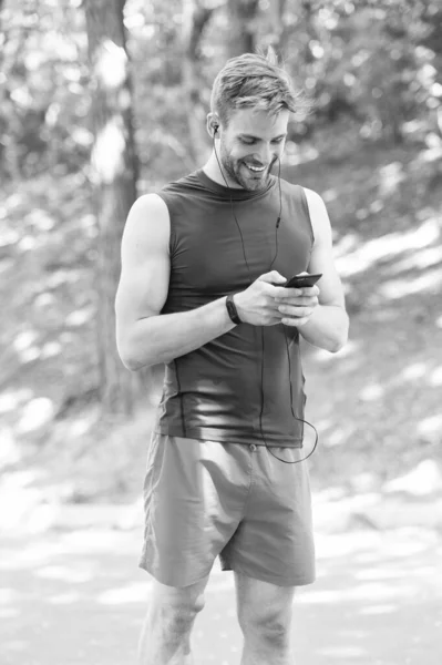 fitness blog. workout. Fitness app. Ui ux concept. gadget in modern sport. muscular man in fitness bracelet. sport app on phone. digital sport. smart watch. happy athletic man in sportswear online