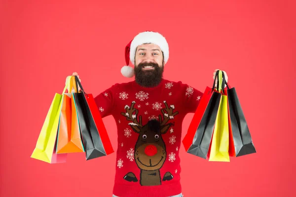 Seasonal sale. Winter shopping on budget. Upgrade your wardrobe. Man bearded hipster wear christmas sweater hold shopping bags. Black friday. Buy gifts. Shopping for presents. Visit shopping mall — Stock Photo, Image