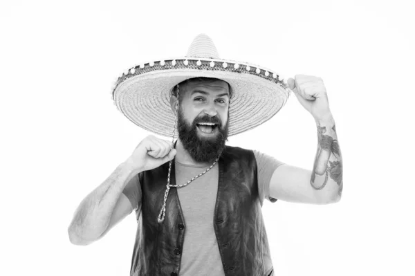Adding hat to his spanish costume. Bearded man smiling in traditional sombrero hat. Happy hipster with beard and mustache wearing casual clothes and mexican hat. Mexican man in traditional straw hat — Stock Photo, Image