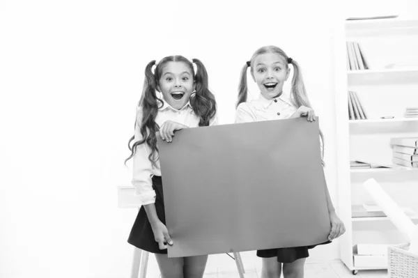 Schoolgirls holding banner announcement. Children greetings copy space. Happy holidays. Congratulations to you. September 1. Congratulations concept. Amazing news. Girls hold congratulations banner