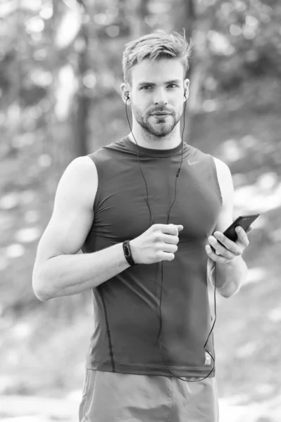 measuring heart rate. sport app on phone. digital sport. smart watch. athletic man in sportswear. outdoor workout. Fitness app. Ui ux concept. gadget in modern sport. muscular man in fitness bracelet