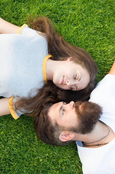 Freshness and peace. Hipster bearded man and girl happy carefree enjoy spring nature top view. Relax on spring grass. Feel free. Spring time. Youth and freedom. Couple in love relaxing lay meadow — Stock Photo, Image